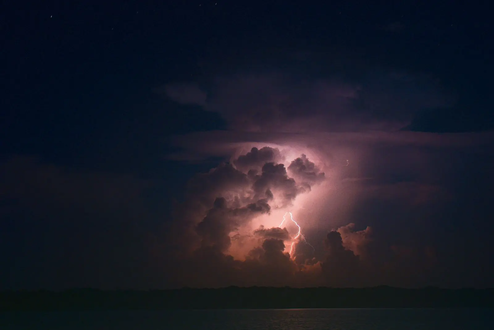 Lightning storm over a dark horizon