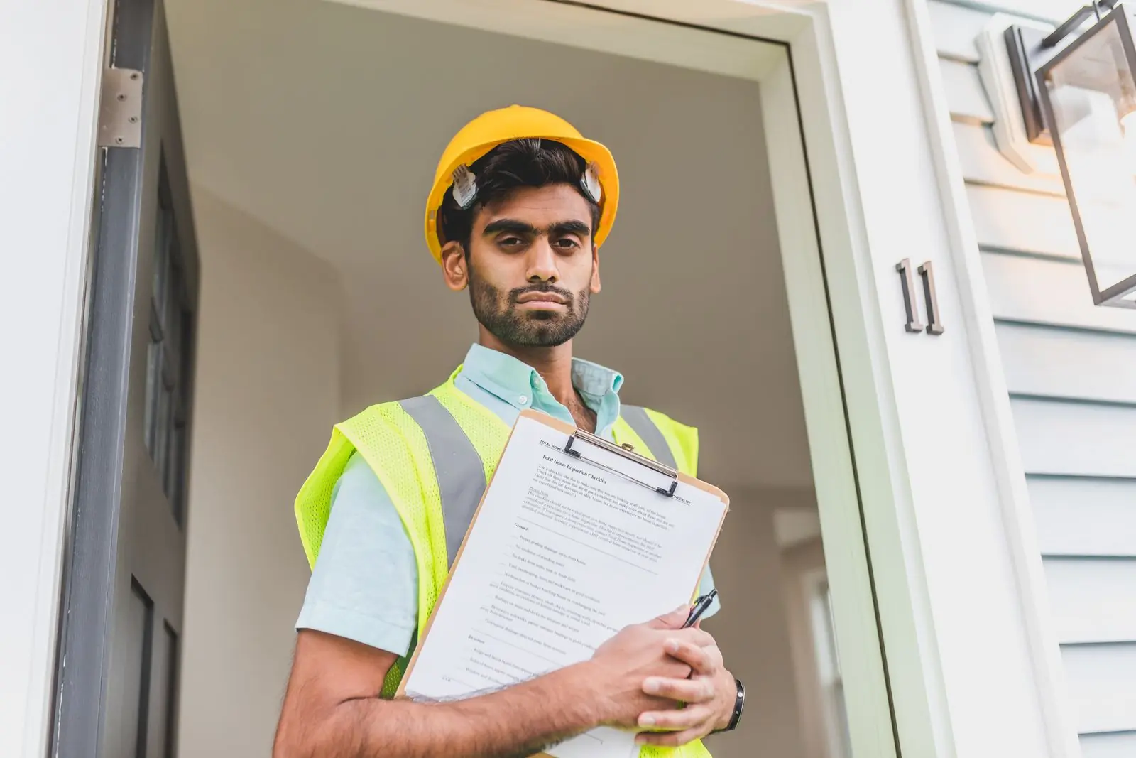 Inspector with a clipboard conducting a property assessment